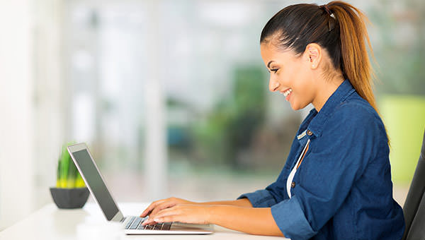 bigstock-cheerful-woman-using-laptop-co-66352138